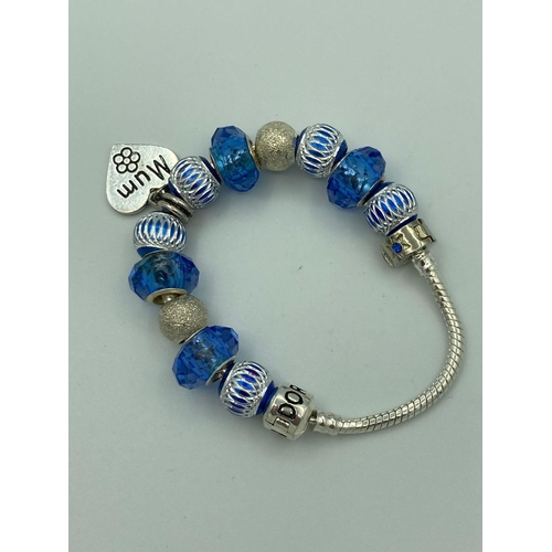 160 - SILVER BRACELET having Silver Sided Blue Charms with clasp marked PANDORA 925 SILVER. To include hea... 