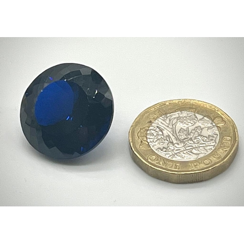 529 - A 36ct Round Cut Dark Blue Gemstone. Well-faceted. 20mm upper diameter. No certificate so a/f.