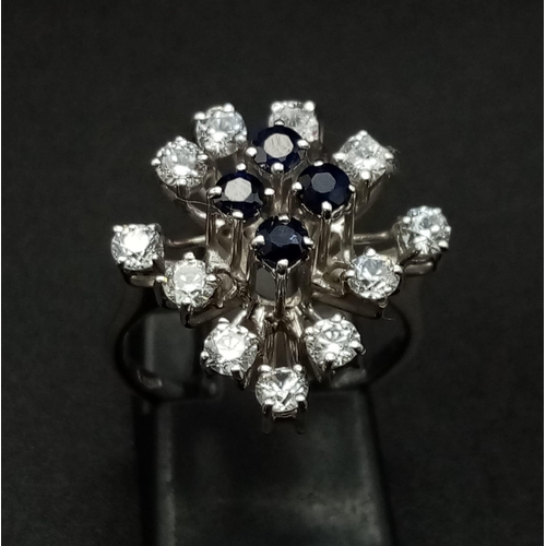 176 - An 18K White Gold, Blue and White Sapphire Floral Burst Ring. 1.5ct. Size N 1/2. 4.72g total weight.