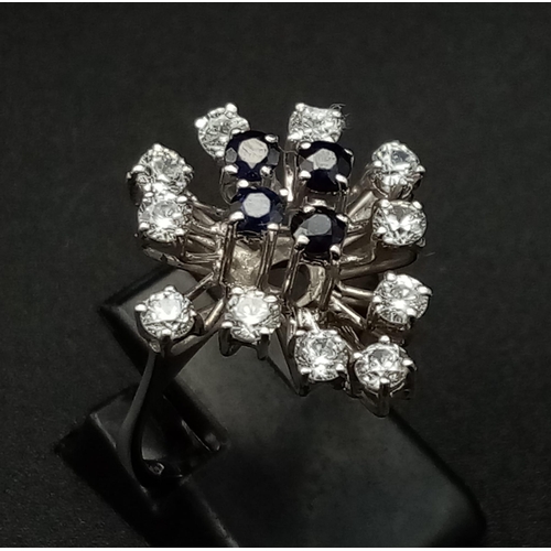 176 - An 18K White Gold, Blue and White Sapphire Floral Burst Ring. 1.5ct. Size N 1/2. 4.72g total weight.