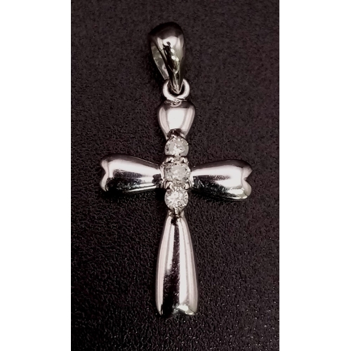 423 - 9K WHITE GOLD DIAMOND SET CROSS 0.9G