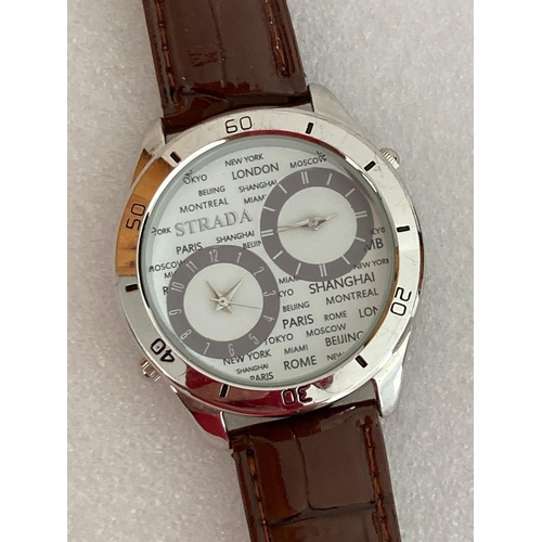 470 - STRADA ‘WORLD TIME’  WRISTWACH Having large silver tone face with twin dials. Numbered bezel with br... 