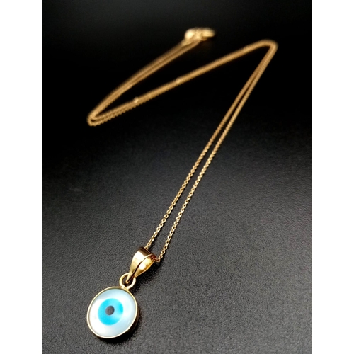 660 - An Evil Eye Pendant set in Gold on an 18K Gold Necklace. 
2cm and 40cm. 1.45g total weight.