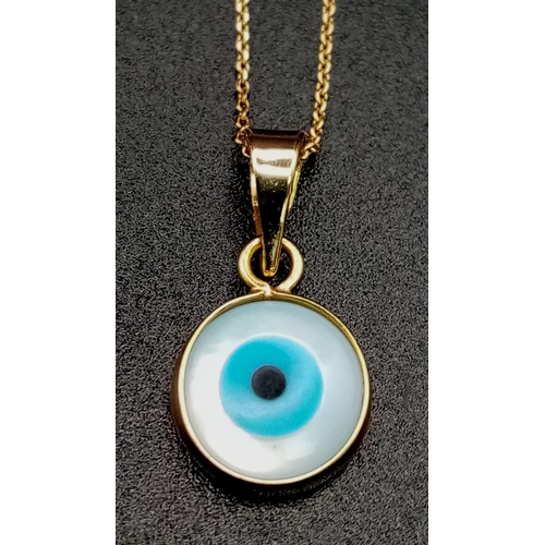 660 - An Evil Eye Pendant set in Gold on an 18K Gold Necklace. 
2cm and 40cm. 1.45g total weight.