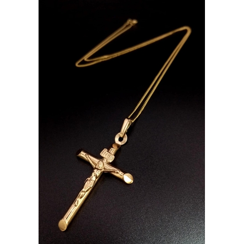 612 - A 9K Yellow Gold Cross Pendant on a 9K Yellow Gold Disappearing Necklace. 4.5cm and 38cm. 2g total w... 