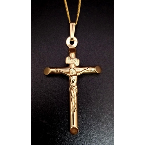 612 - A 9K Yellow Gold Cross Pendant on a 9K Yellow Gold Disappearing Necklace. 4.5cm and 38cm. 2g total w... 