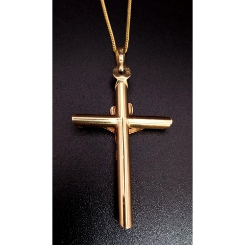 612 - A 9K Yellow Gold Cross Pendant on a 9K Yellow Gold Disappearing Necklace. 4.5cm and 38cm. 2g total w... 