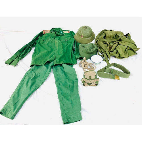 62 - Vietnam War Era N.V.A Backpack containing helmet, shirt, trousers, rice bowl, belt and cap.