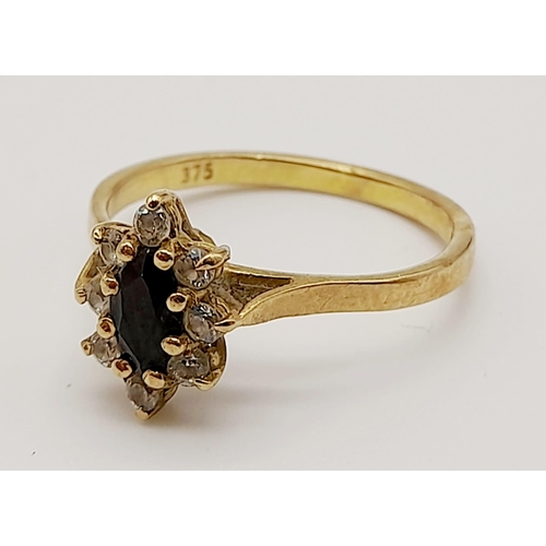 624 - A 9K Yellow Gold Sapphire and White Stone Ring. Size K. 1.62g total weight.