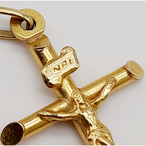 646 - A 9K Yellow Gold Crucifix Pendant. 3.5cm. 0.9g