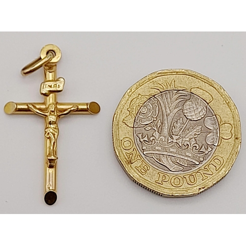 646 - A 9K Yellow Gold Crucifix Pendant. 3.5cm. 0.9g