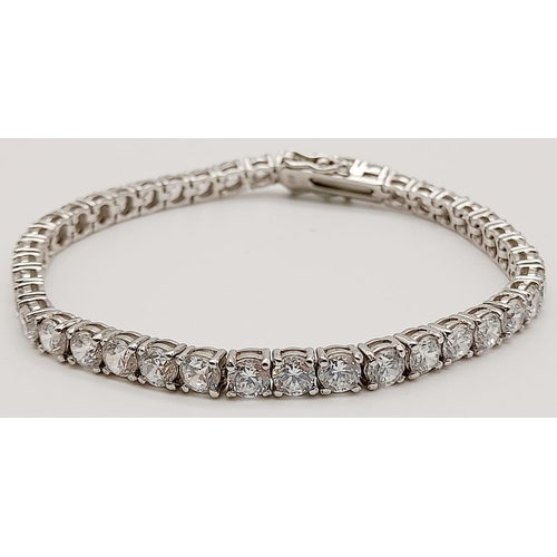 653 - A 925 Silver Tennis White Stone Bracelet. 19cm. Good quality round cut CZ stones. 13.31g total weigh... 