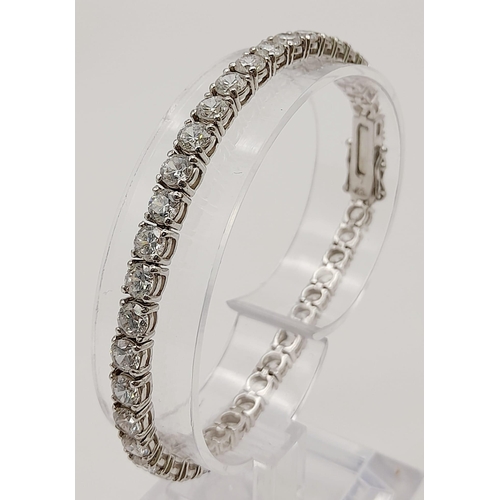 653 - A 925 Silver Tennis White Stone Bracelet. 19cm. Good quality round cut CZ stones. 13.31g total weigh... 