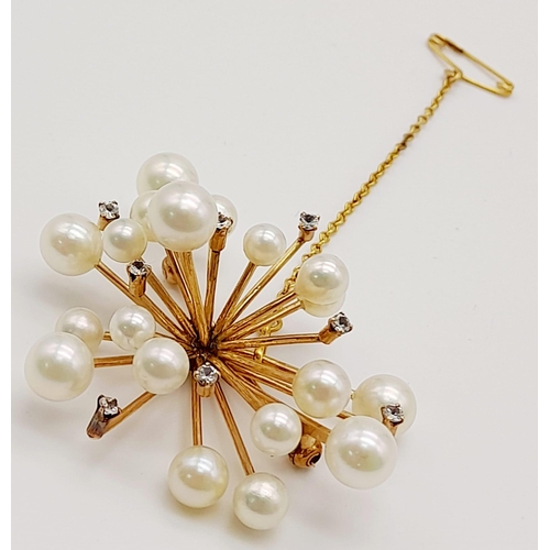 655 - A 14K Yellow Gold and Pearl Floral Burst Brooch. White stone decoration. 11.44g total weight.