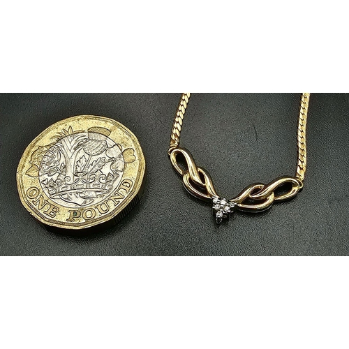 604 - A 9K Yellow Gold Herringbone Necklace with a Diamond Drop Attachment. Six small diamonds amidst tear... 