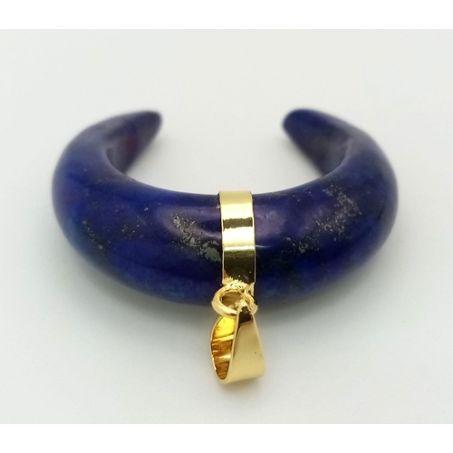 1414 - A Lapis Lazuli Crescent Pendant. Gilded attachment. 3 x 3.5cm.