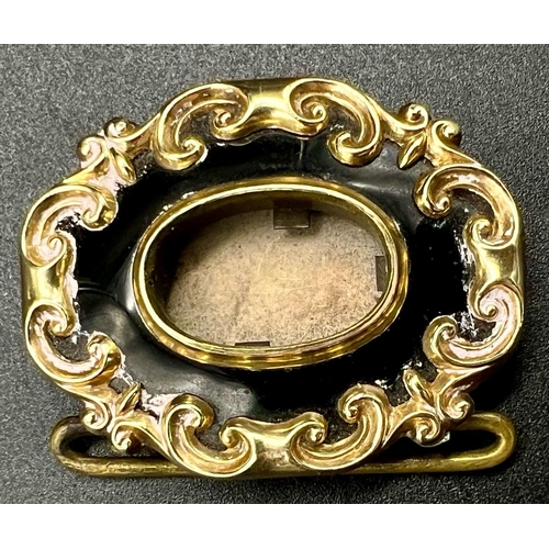 1527 - A Victorian Mid-Karat Gold and Onyx Memorial Brooch. Inscription verso for 1847. Scrolled decoration... 