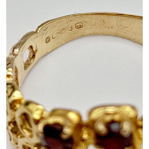 224 - A vintage, 9 K yellow gold ring with seven, excellent quality, round cut garnets. Ring size: Q, weig... 