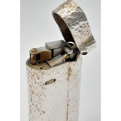 547 - A Vintage Dunhill Silver-Plated Lighter. Bark-effect decoration. In good condition but needs some ga... 