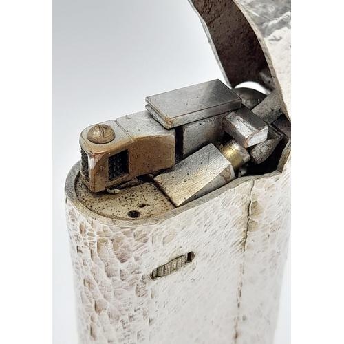 547 - A Vintage Dunhill Silver-Plated Lighter. Bark-effect decoration. In good condition but needs some ga... 