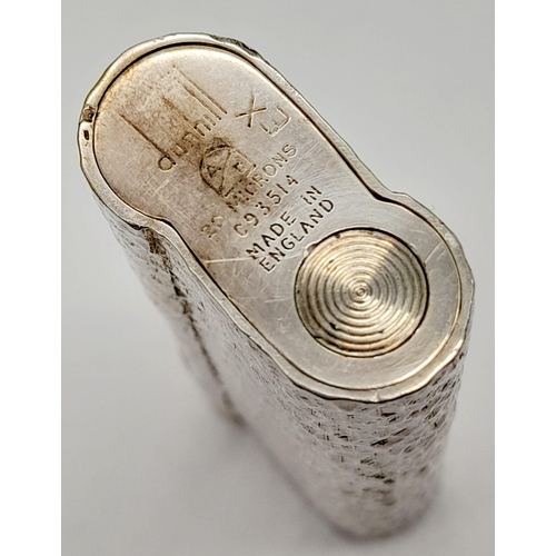 547 - A Vintage Dunhill Silver-Plated Lighter. Bark-effect decoration. In good condition but needs some ga... 