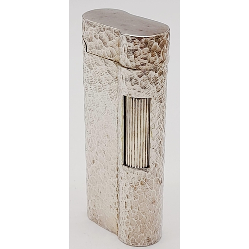 547 - A Vintage Dunhill Silver-Plated Lighter. Bark-effect decoration. In good condition but needs some ga... 