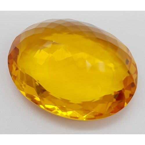 168 - A gorgeous, large (51.05 carats) citrine. Oval cut with strong colour saturation and uniformity. Fla... 