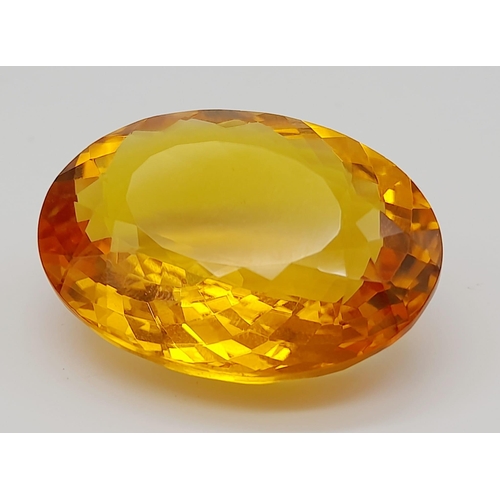 168 - A gorgeous, large (51.05 carats) citrine. Oval cut with strong colour saturation and uniformity. Fla... 