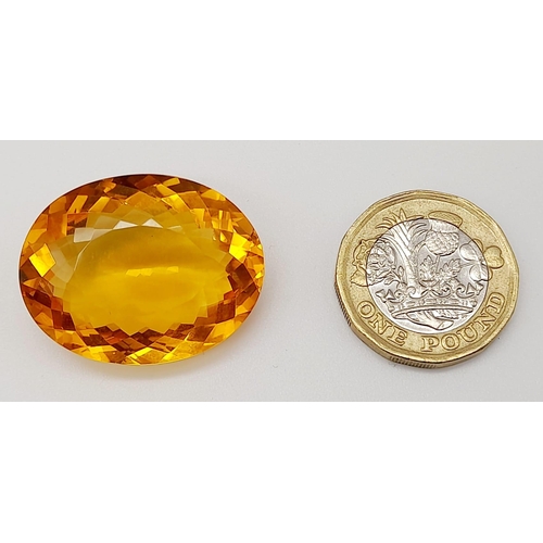 168 - A gorgeous, large (51.05 carats) citrine. Oval cut with strong colour saturation and uniformity. Fla... 