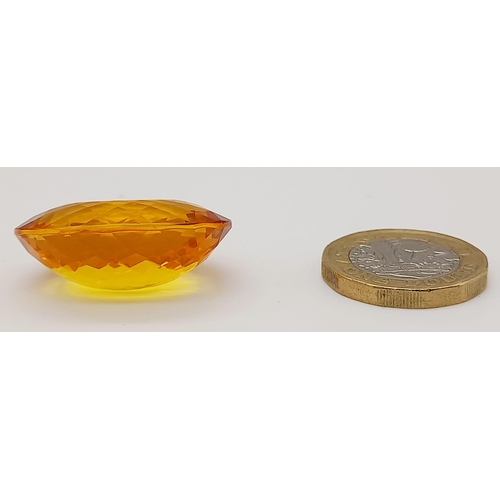 168 - A gorgeous, large (51.05 carats) citrine. Oval cut with strong colour saturation and uniformity. Fla... 