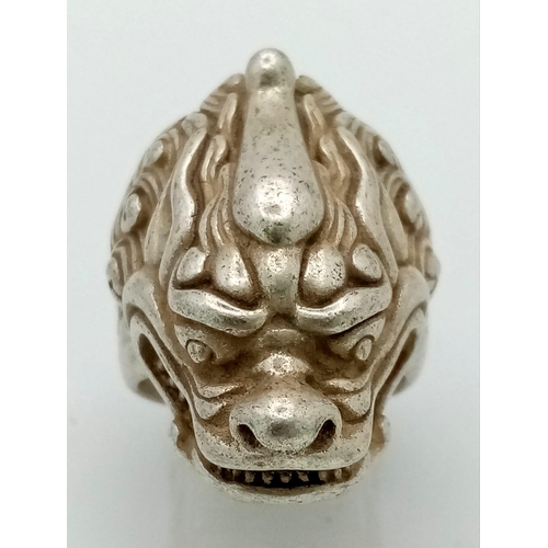 175 - An antique Chinese silver dragon ring with Mandarin writing on outer and inner surface of the ring, ... 