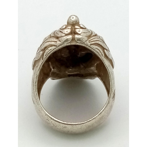 175 - An antique Chinese silver dragon ring with Mandarin writing on outer and inner surface of the ring, ... 