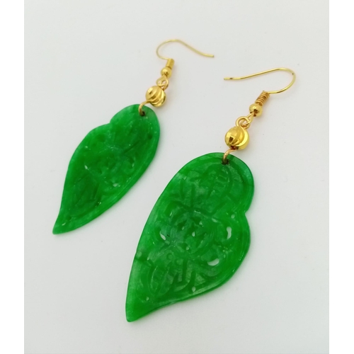 210 - A spectacular, intricately carved, green jade, pair of earrings. Exquisitely presented in a Chinese,... 