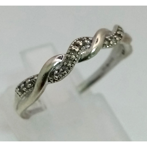 401 - A 9K White Gold Diamond Twist Ring. Size Q. 1.93g total weight.