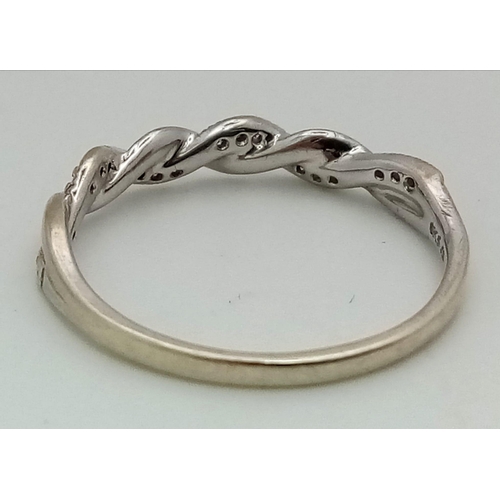 401 - A 9K White Gold Diamond Twist Ring. Size Q. 1.93g total weight.