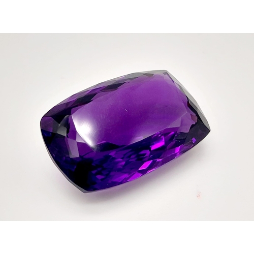 203 - A very admirable, large (22.85 carats) amethyst. Cushion cut, with strong colour saturation and unif... 