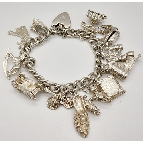 337 - A 925 Silver Charm Bracelet with an Eclectic Mix of 12 Charms. Including: Telephone, poodle and the ... 