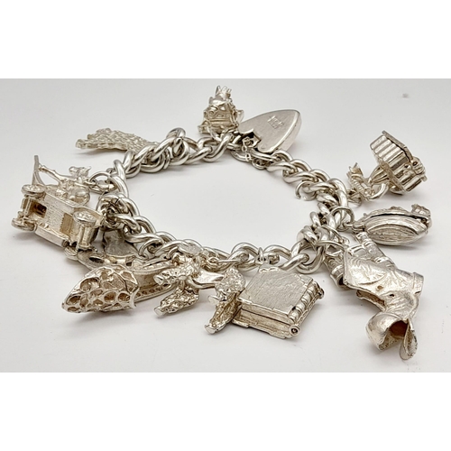 337 - A 925 Silver Charm Bracelet with an Eclectic Mix of 12 Charms. Including: Telephone, poodle and the ... 