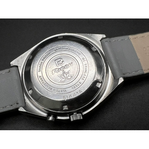 1197 - A Vintage Ricoh Automatic Gents Watch. Grey leather strap. Stainless steel case - 40mm. Two tone dia... 