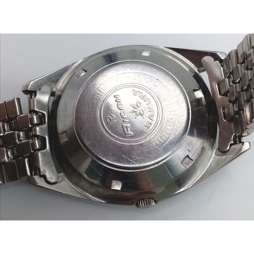 1238 - A Vintage Ricoh Automatic 21 Jewel Gents Watch. Stainless steel strap and case - 38mm. Cream dial wi... 