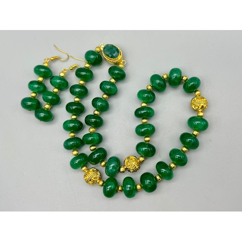 126 - An impressive emerald necklace and earrings set with large cabochons in a presentation case. Necklac... 