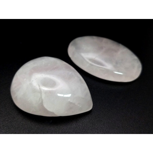 1302 - A Lot of 2 Cabochon Rose Quartz. Included: a 57.705ct Oval and a 73.15ct Pear