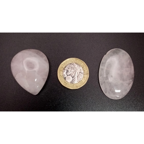 1302 - A Lot of 2 Cabochon Rose Quartz. Included: a 57.705ct Oval and a 73.15ct Pear