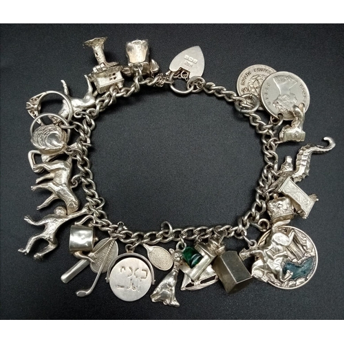 441 - A 925 Silver Charm Bracelet with an Eclectic Mix of 24 Charms. Including: Antique foreign coins, can... 