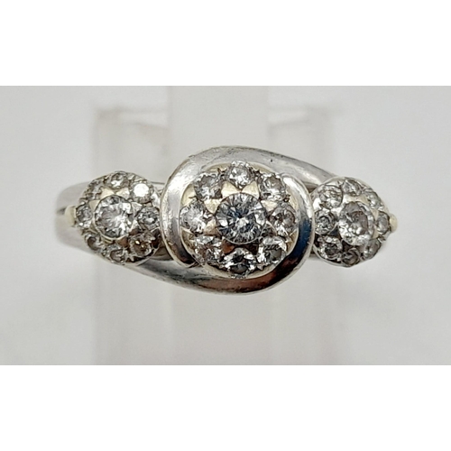 72 - A 9K White Gold Triple Diamond Cluster Ring. Three diamonds each with a halo of diamonds. Size N. 3.... 