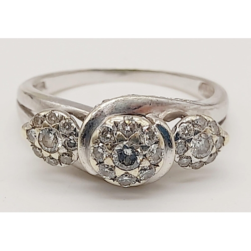 72 - A 9K White Gold Triple Diamond Cluster Ring. Three diamonds each with a halo of diamonds. Size N. 3.... 