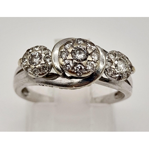 72 - A 9K White Gold Triple Diamond Cluster Ring. Three diamonds each with a halo of diamonds. Size N. 3.... 