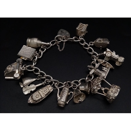 80 - A 925 Silver Charm Bracelet with an Eclectic Mix of 14 Charms. Including: Telephone, windmill and a ... 