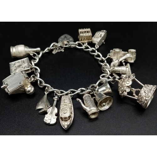 80 - A 925 Silver Charm Bracelet with an Eclectic Mix of 14 Charms. Including: Telephone, windmill and a ... 