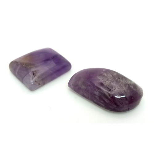 911 - 2 Natural Amethysts. Include: 22.20ct Rectangle & 29.15ct Fancy Shape.